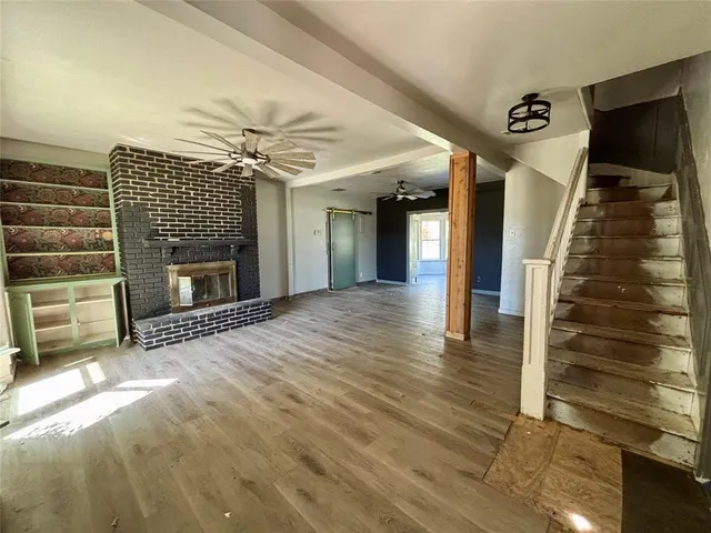 wooden floor in an empty room with a fireplace
