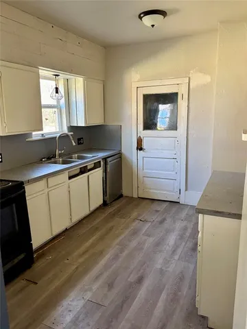 a kitchen with a sink and cabinets
