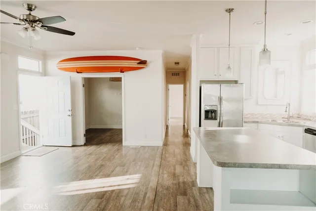 a kitchen with white cabinets and window