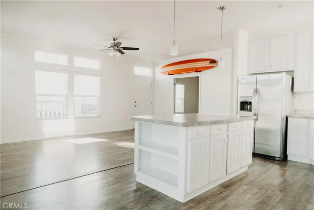 a view of a small space with wooden floor and a window