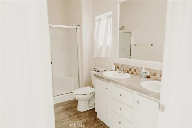 a bathroom with a toilet a sink and shower