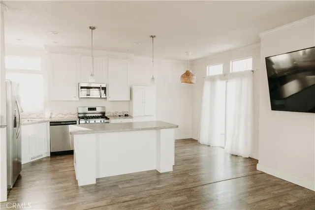 a kitchen with granite countertop a stove and a sink