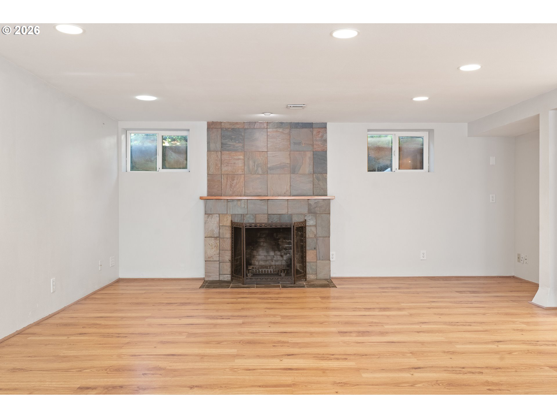 7541 Northeast Alameda Street Portland, OR 97213 - Photo 27 of 35 a view of empty room with wooden floor and fireplace