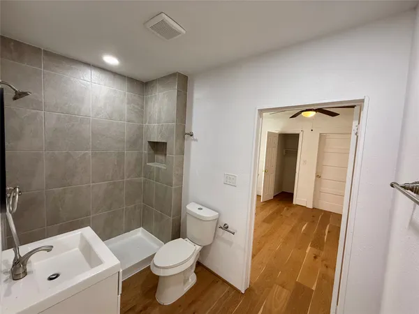 a bathroom with a toilet sink and shower