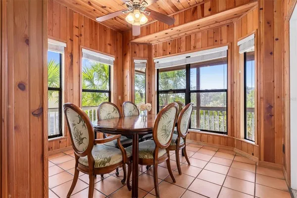 a bedroom with a bed a window and potted plant