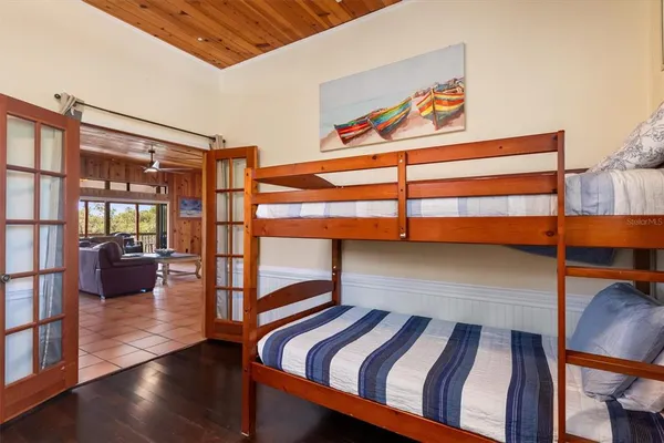 a balcony with wooden floor and outdoor seating
