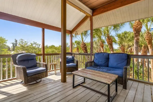 a bedroom with a bed a flat screen tv and a chandelier