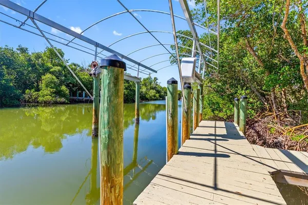an aerial view of lake and residential houses with outdoor space