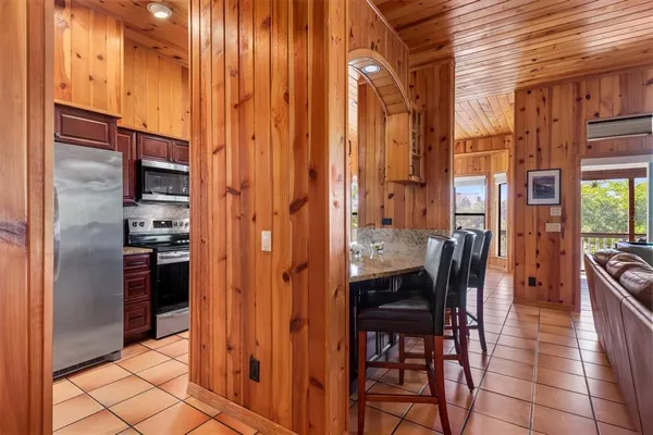 a kitchen with stainless steel appliances granite countertop a sink a stove and a refrigerator