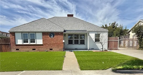 a front view of a house with a garden and yard