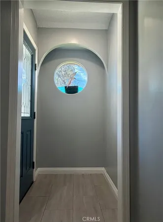 an empty room with wooden floor and fireplace