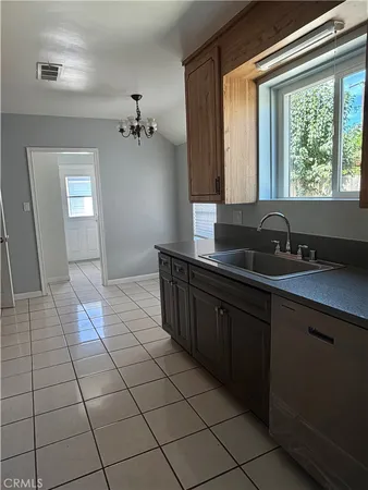 a kitchen with a sink a stove and a microwave