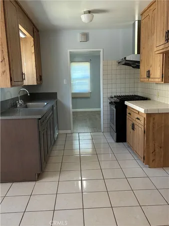 a bathroom with a granite countertop sink mirror and toilet