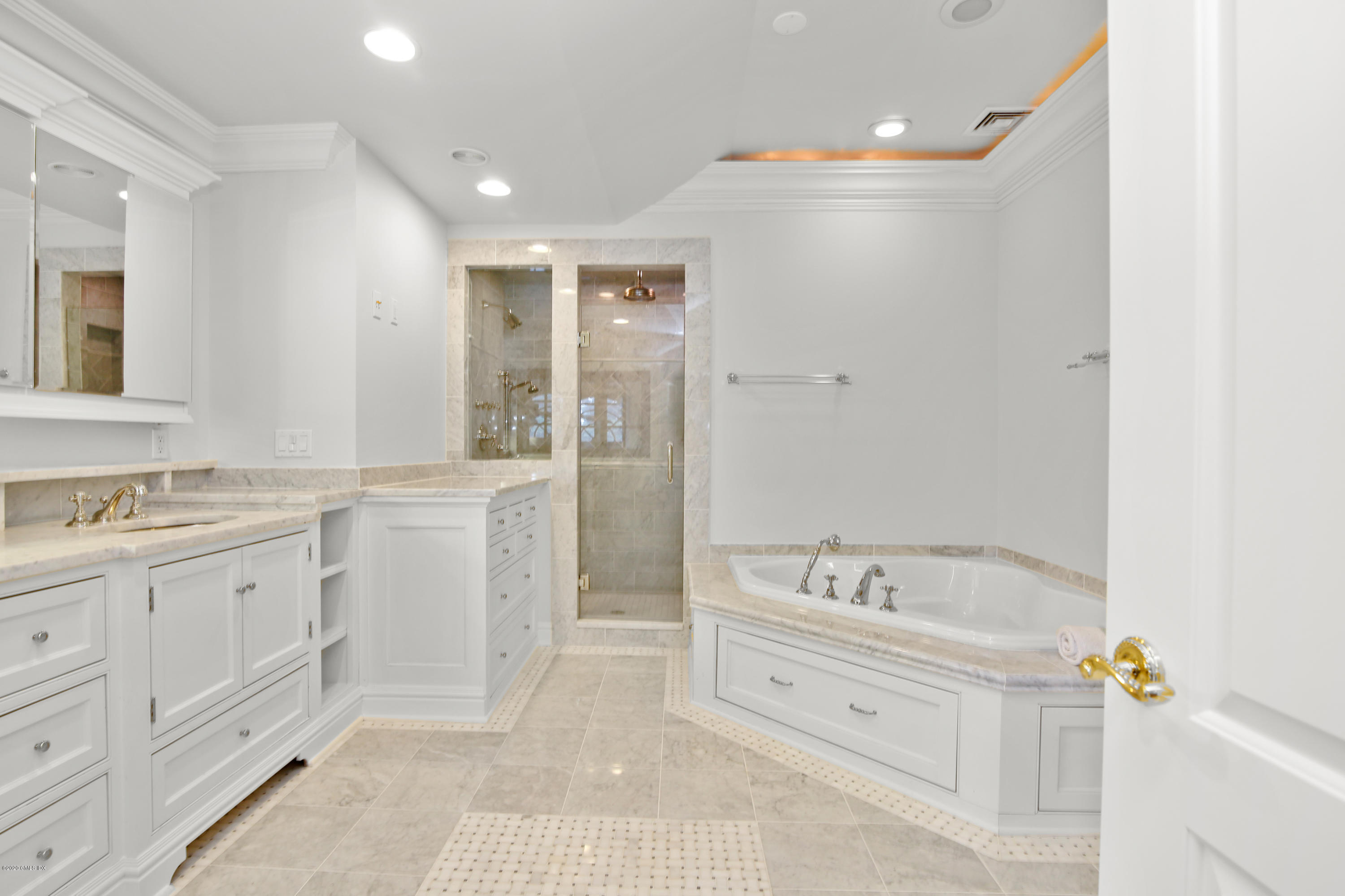 99 Valley Road, Unit E Cos Cob, CT 06807 - Photo 19 of 28 a spacious bathroom with a double vanity sink a mirror a bathtub and