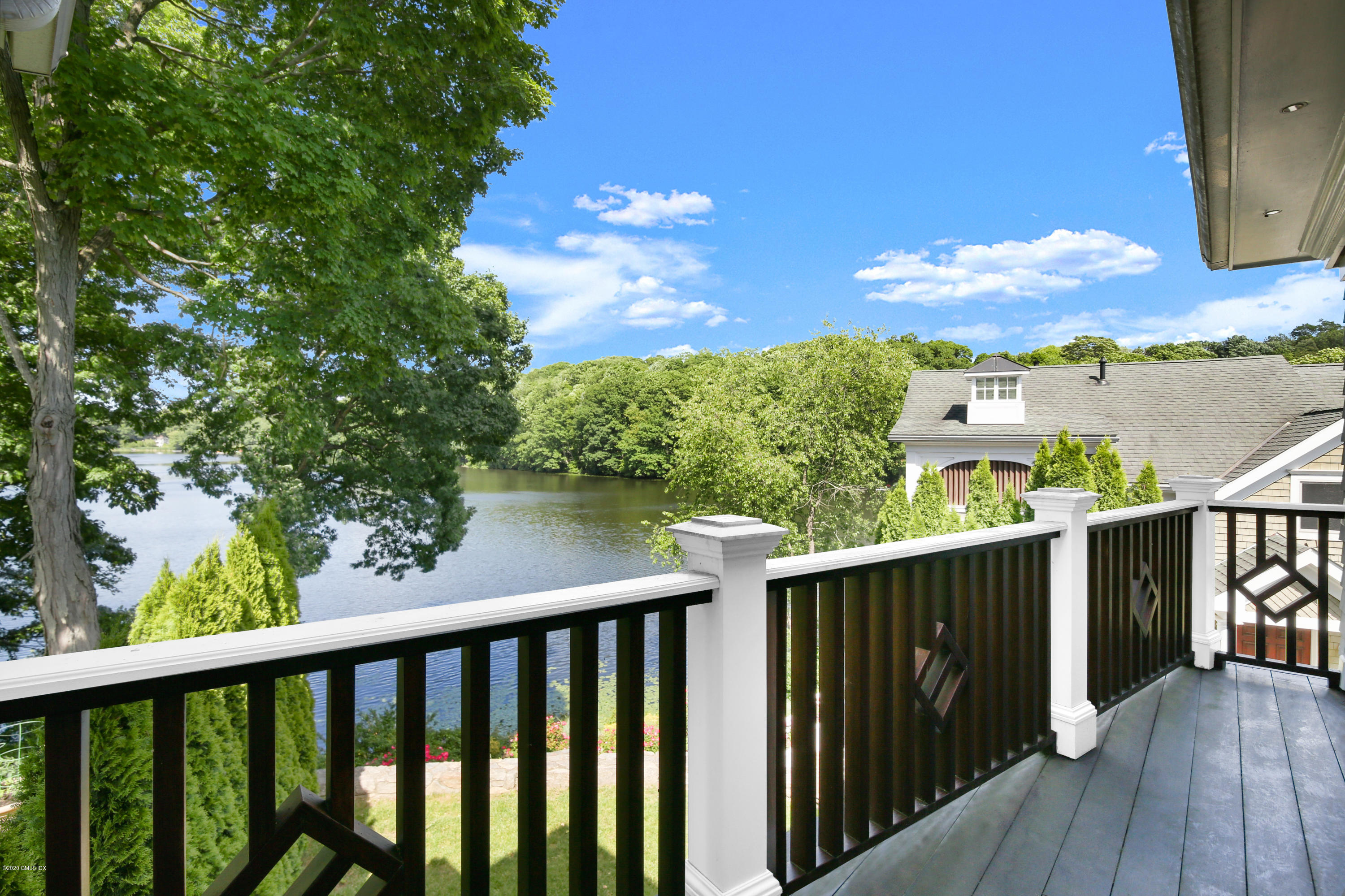 99 Valley Road, Unit E Cos Cob, CT 06807 - Photo 20 of 28 a view of a balcony with wooden floor & fence
