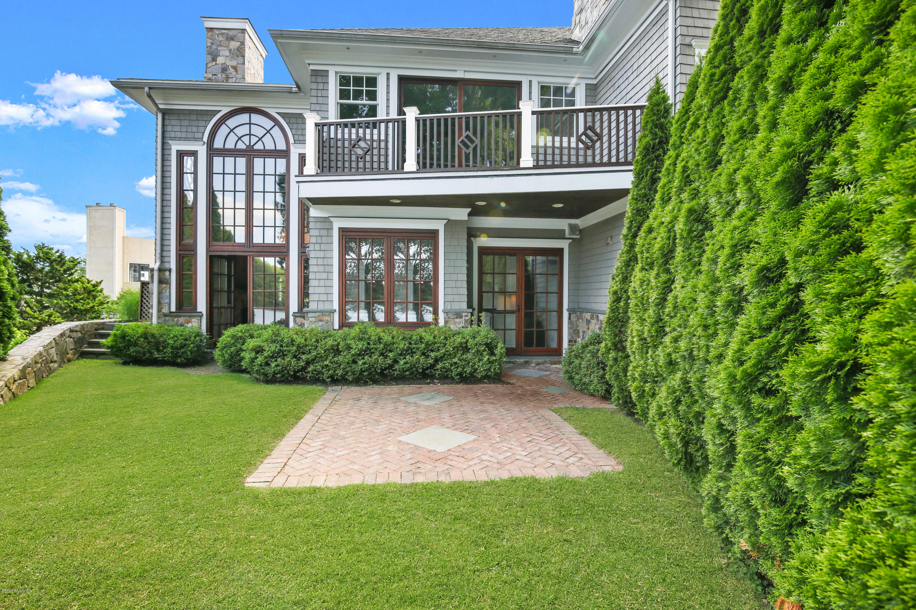 99 Valley Road, Unit E Cos Cob, CT 06807 - Photo 2 of 28 front view of a house with a yard