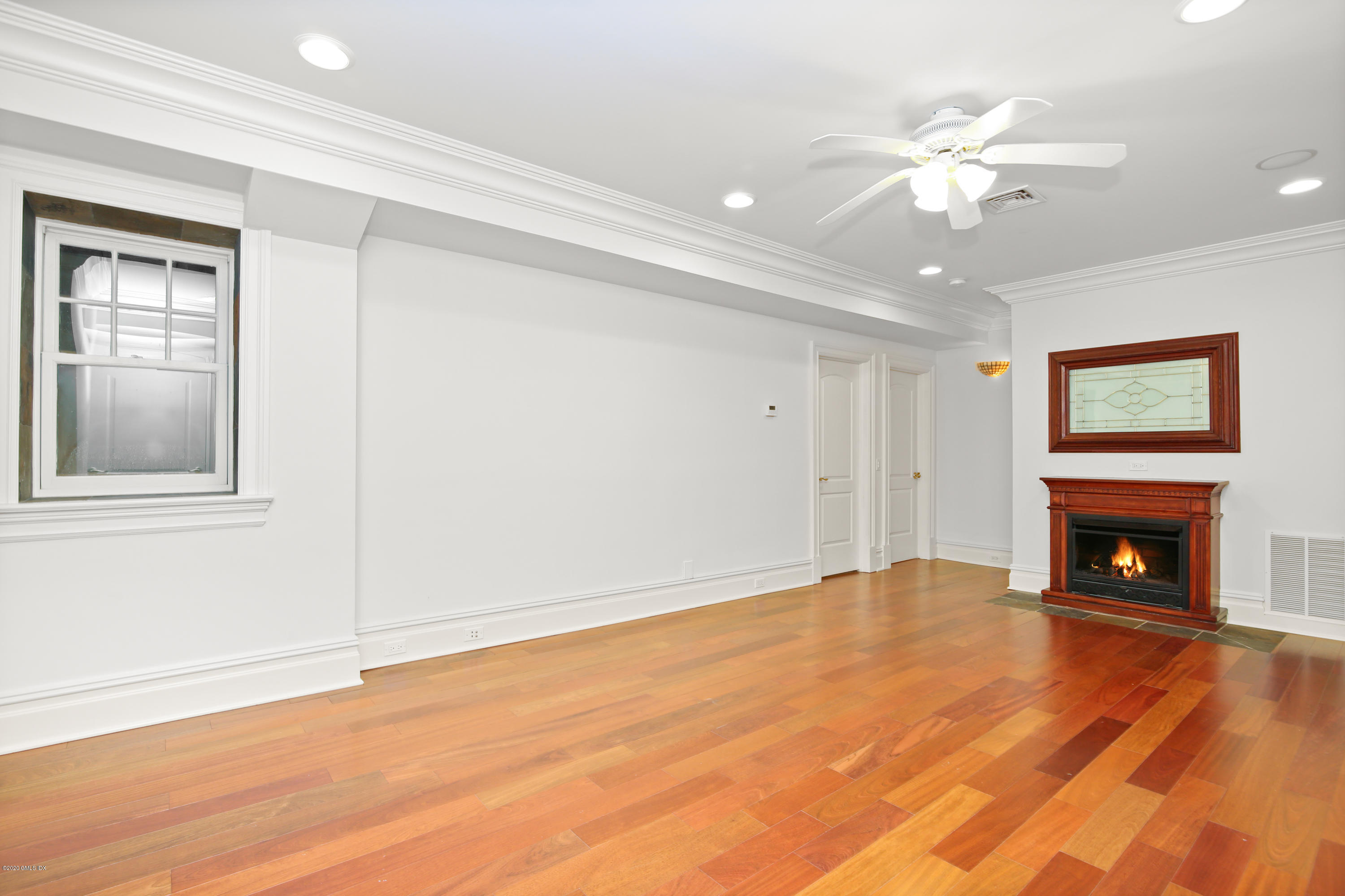 99 Valley Road, Unit E Cos Cob, CT 06807 - Photo 23 of 28 a view of an empty room with window and fire place