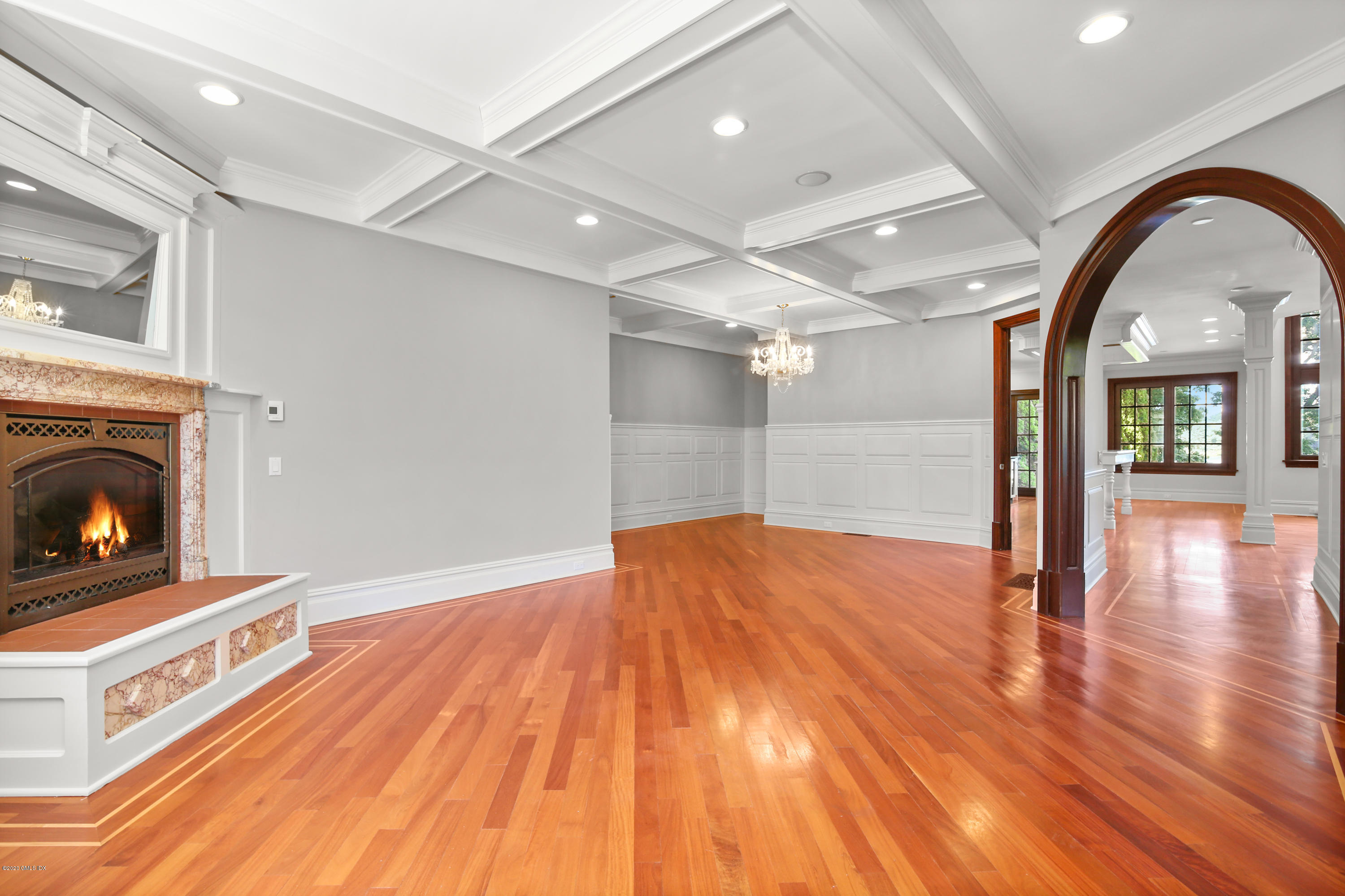 99 Valley Road, Unit E Cos Cob, CT 06807 - Photo 9 of 28 a view of empty room with wooden floor and fireplace