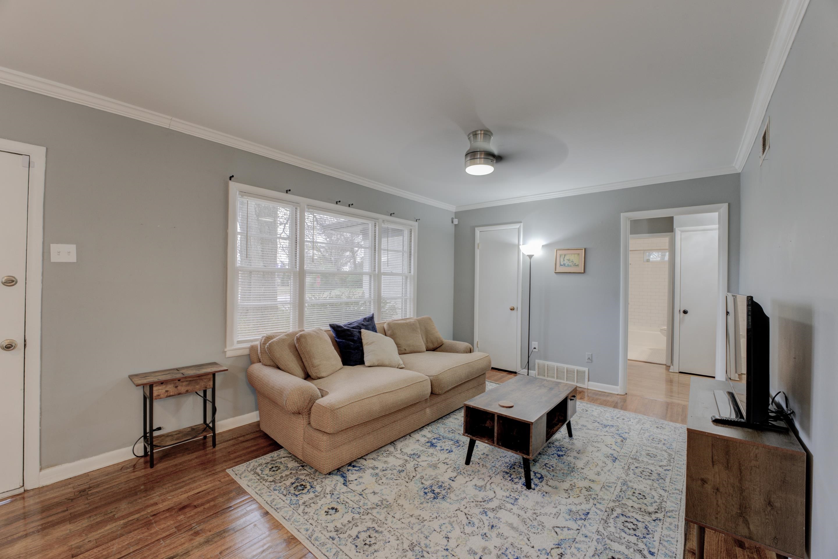 4990 Sea Isle Road Memphis, TN 38117 - Photo 5 of 25 a living room with furniture a flat screen tv and a window