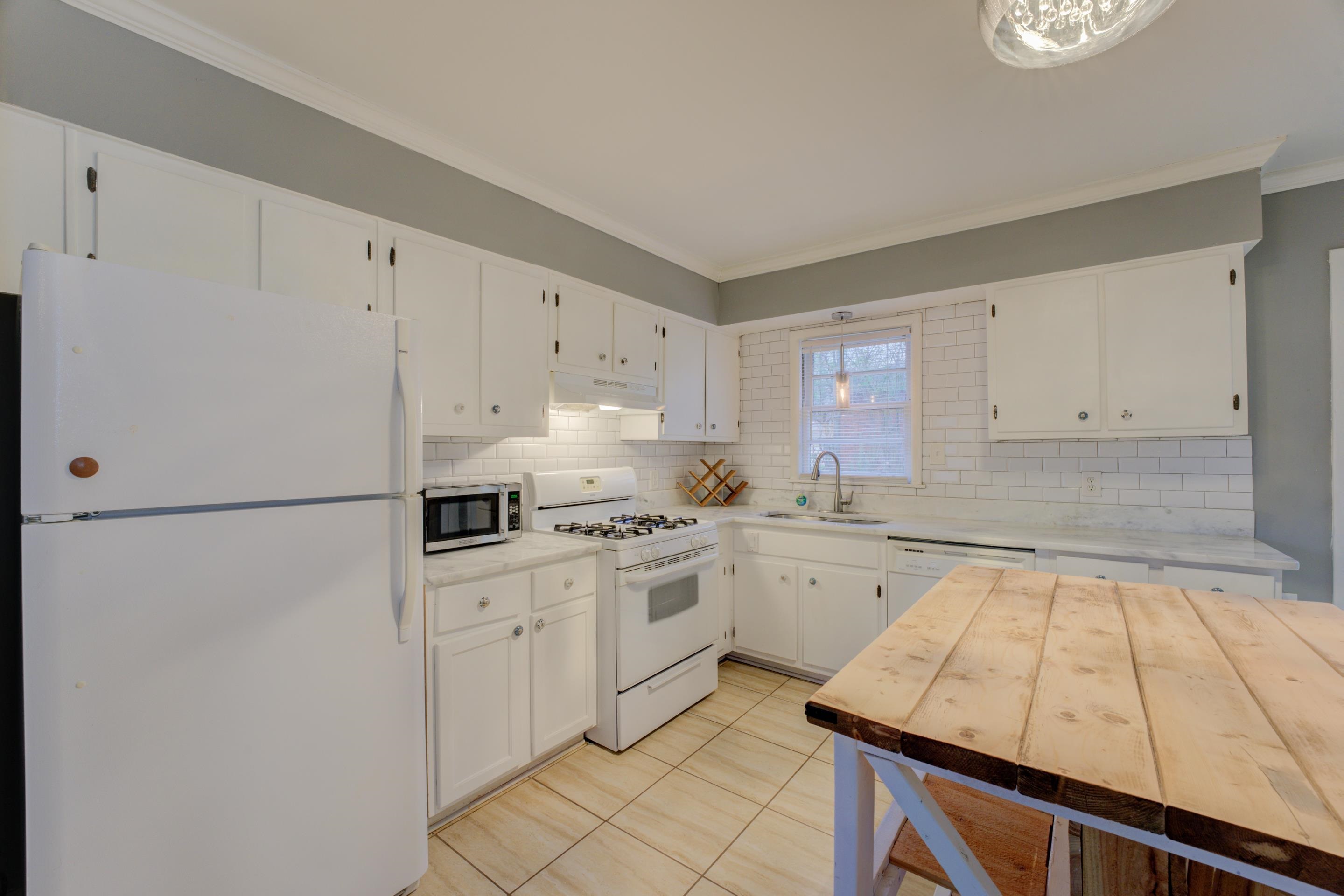 4990 Sea Isle Road Memphis, TN 38117 - Photo 8 of 25 a kitchen with white cabinets and white appliances