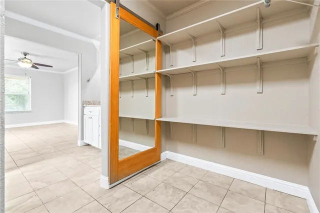 a view of an empty room with cabinet and entryway