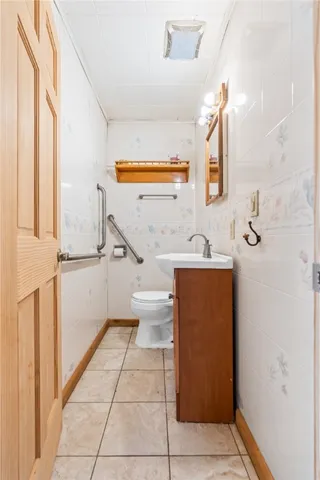 a bathroom with a sink a toilet and mirror