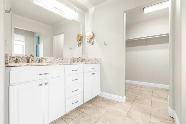 a spacious bathroom with a granite countertop sink and a mirror