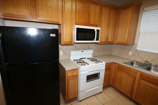 a kitchen with a stove microwave and sink
