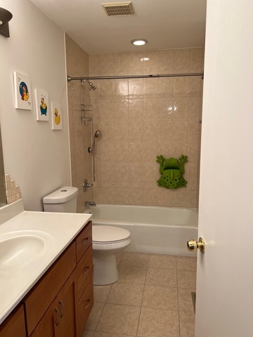 249 Shadow Bend Drive, Unit 249 Wheeling, IL 60090 - Photo 12 of 17 a bathroom with a sink a toilet and shower