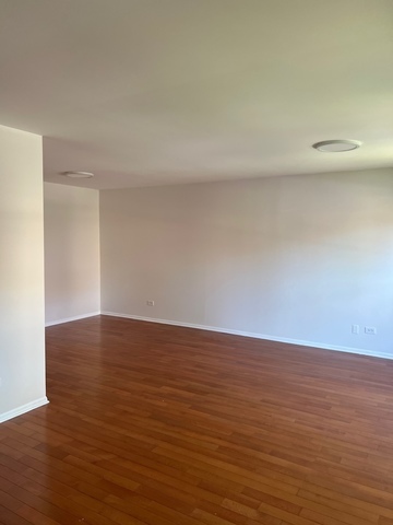 249 Shadow Bend Drive, Unit 249 Wheeling, IL 60090 - Photo 6 of 17 a view of an empty room and wooden floor