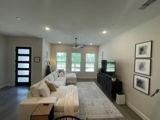 a living room with furniture fireplace and a flat screen tv