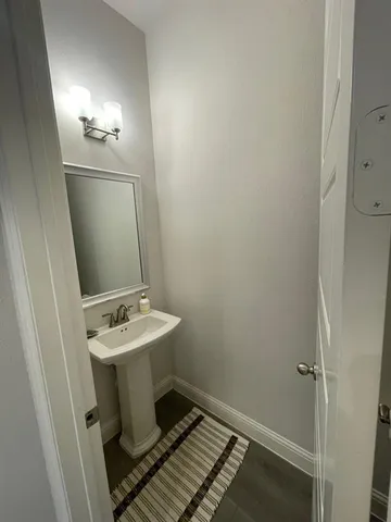 a bathroom with a sink toilet and mirror