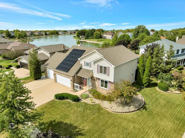 an aerial view of a house with a yard basket ball court and outdoor seating