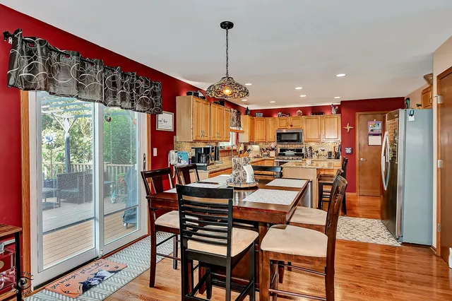 a dining room with furniture a chandelier and wooden floor