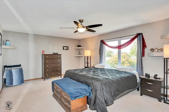 a bedroom with a bed dresser and a window