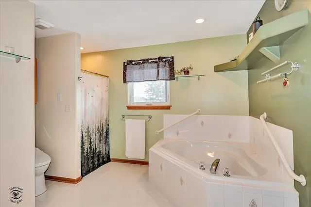 a bathroom with a tub and shower