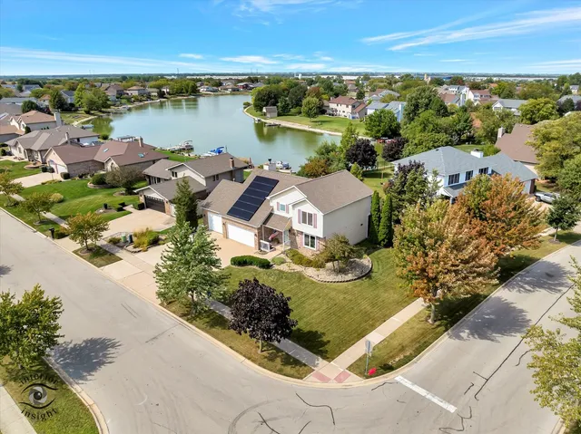 an aerial view of a house with a lake view