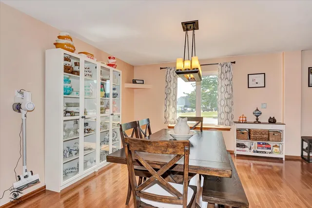 a dining room with furniture and a window