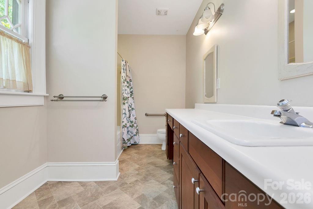 208 West Probart Street Brevard, NC 28712 - Photo 33 of 48 a bathroom with a sink and a mirror