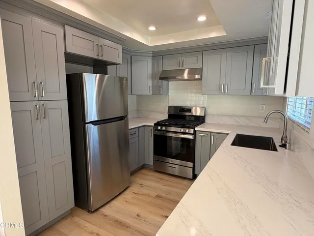 a kitchen with a refrigerator and a sink