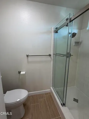 a bathroom with a toilet and a shower