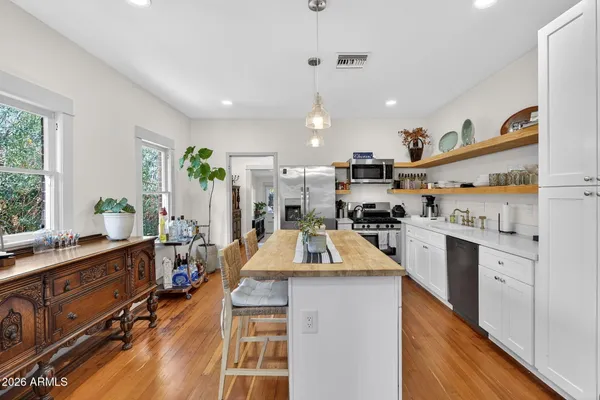 a view of a kitchen counter top space with sink and wooden floor