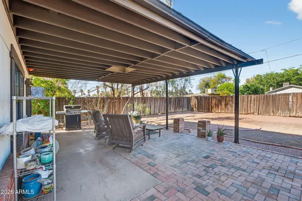 a front view of a house with a yard table and chairs