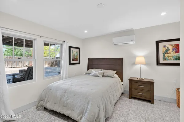a view of a backyard with a patio and palm tree