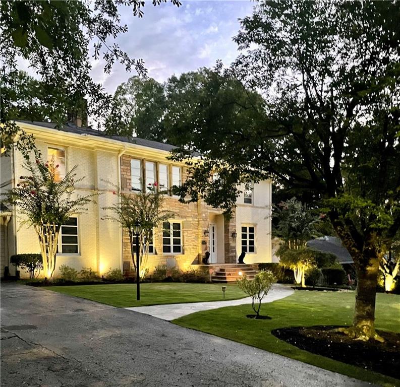 1756 Friar Tuck Road Northeast Atlanta, GA 30309 - Photo 1 of 1 a view of a white house next to a yard with big trees