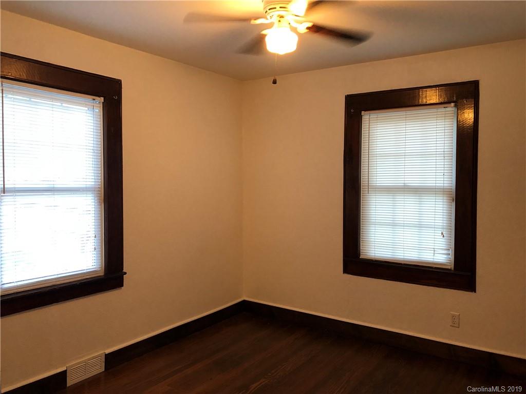 726 Valleydale Road Charlotte, NC 28214 - Photo 15 of 32 a view of an empty room with wooden floor and a window