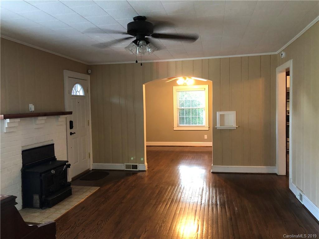 726 Valleydale Road Charlotte, NC 28214 - Photo 3 of 32 a view of empty room with wooden floor and fan