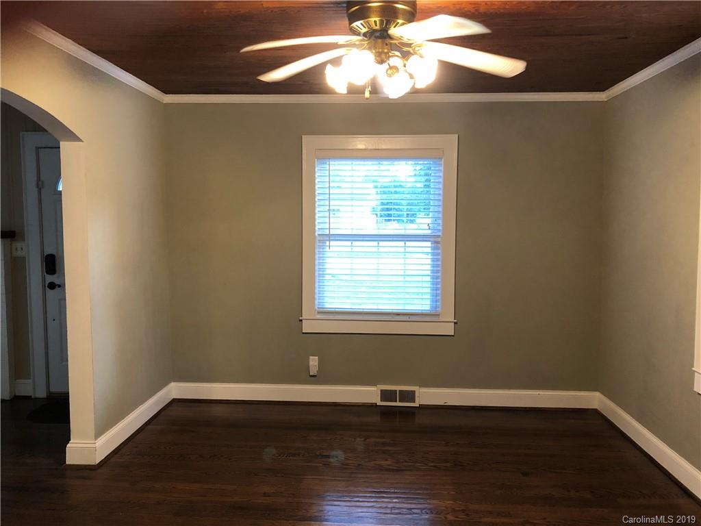 726 Valleydale Road Charlotte, NC 28214 - Photo 4 of 32 a view of an empty room with wooden floor and a window