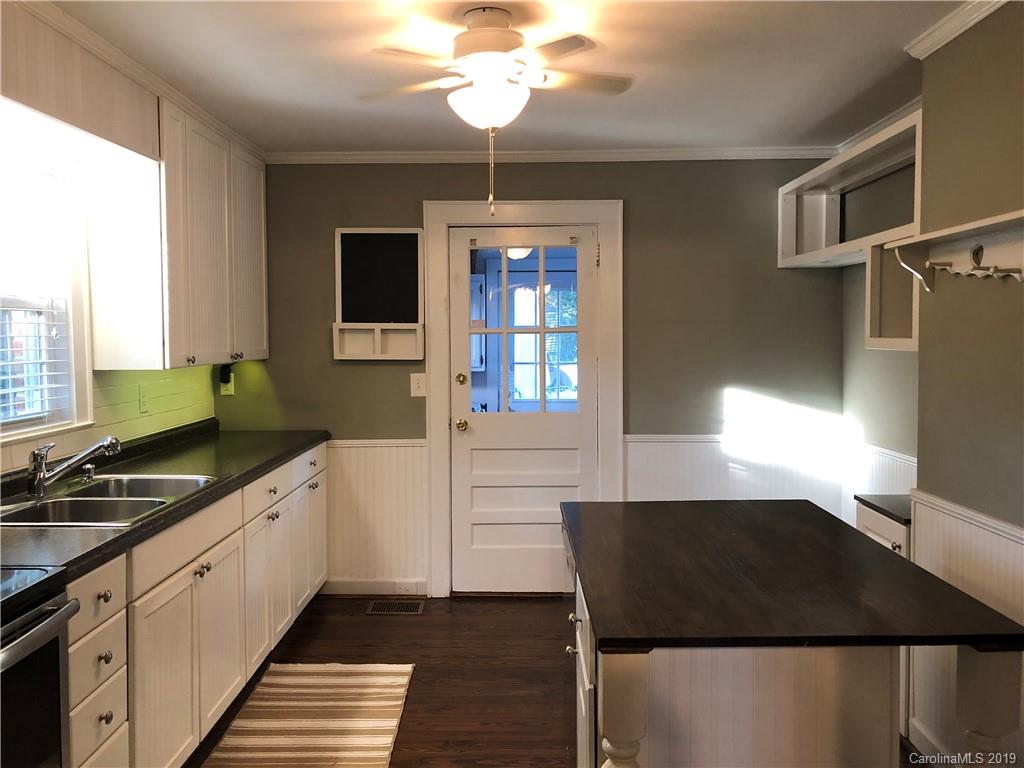 726 Valleydale Road Charlotte, NC 28214 - Photo 5 of 32 a kitchen with a sink stove and cabinets