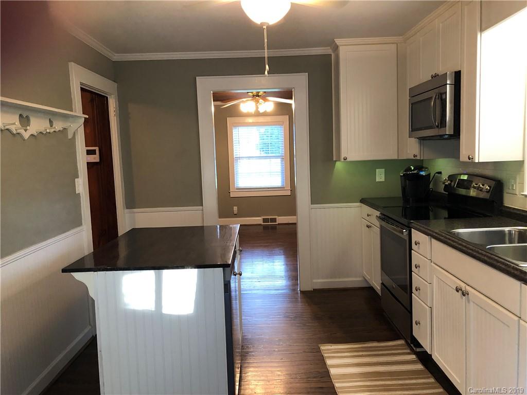 726 Valleydale Road Charlotte, NC 28214 - Photo 6 of 32 a kitchen with a sink and a refrigerator
